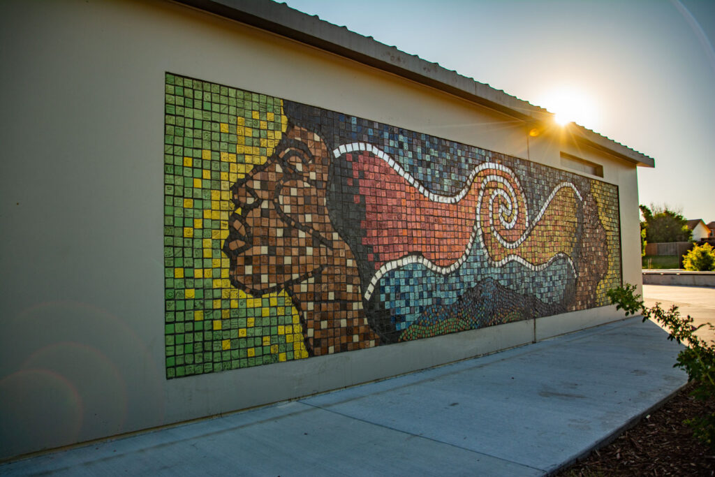 Photo of sun setting over tile mosaic artwork at panorama park