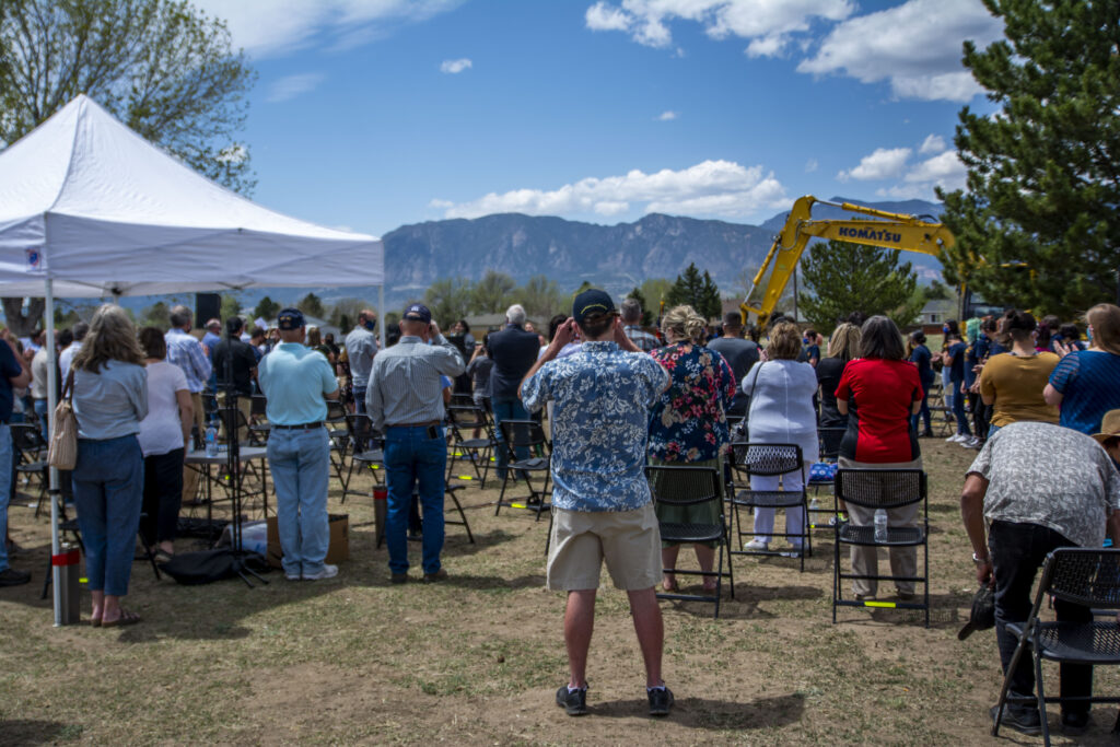 A photo of community members taking photos of the construction